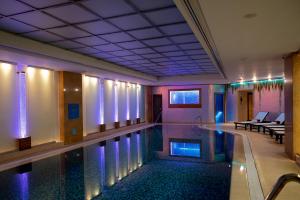 a swimming pool in a hotel with purple lighting at InterContinental - Kyiv by IHG in Kyiv