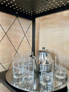 a tray with glasses and a tea kettle on it at Relax in Oued Laou in Oued Laou