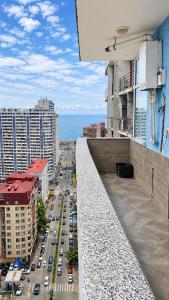 a view from the balcony of a building with cars at dupleqs batumi daRia in Angisa