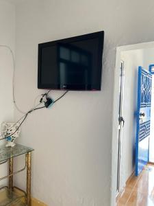 a flat screen tv hanging on a wall at Relax in Oued Laou in Oued Laou