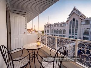 a balcony with a table and chairs on a balcony at Excel Hotel Bangkok former Sri Krungthep Hotel in Bangkok +56 photos