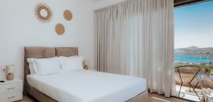a bedroom with a bed and a large window at Apollonia Elounda View Villa in Elounda