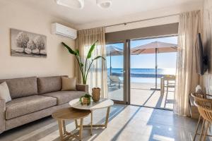 a living room with a couch and a table at Azzurro Luxury Villas in Kolymbia
