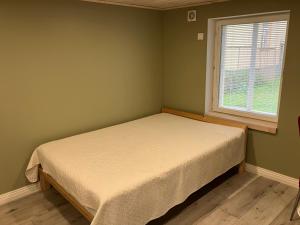 a small bedroom with a bed and a window at Arkaadia in Viljandi