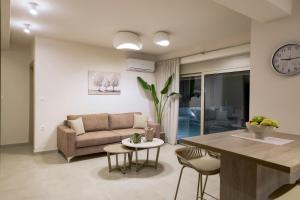 a living room with a couch and a table at Azzurro Luxury Villas in Kolymbia