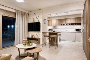 a kitchen and living room with a table and chairs at Azzurro Luxury Villas in Kolymbia