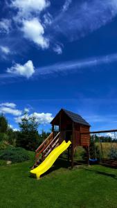 a playground with a slide and a gazebo at Domek na Hubce 1 Blisko Velo Czorsztyn in Maniowy