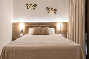 a bedroom with a large white bed with two lights at Azzurro Luxury Villas in Kolymbia +2 photos