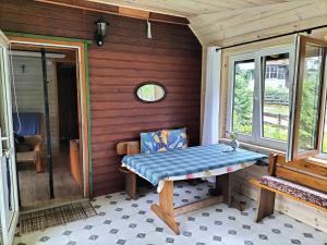 a porch with a bench and a window at Zielony domek na Kaszubach in Raduń