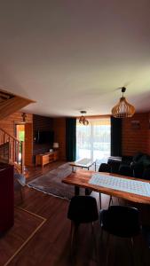 a living room with a table and chairs at Domek na Hubce 1 Blisko Velo Czorsztyn in Maniowy +27 photos