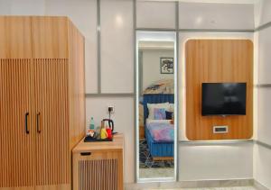 a room with a bedroom with a bed and a mirror at Atlantiis Suites By Signature StayZ Girjaghar Near Vishwanath Temple in Varanasi