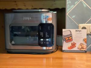 a microwave sitting on a counter next to a box at Juifen in Lenggries