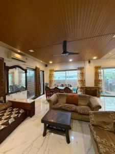 a living room with a couch and a table at Chikku 4 bhk villa in Lonavala