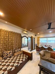 a living room with a couch and a table at Chikku 4 bhk villa in Lonavala +41 photos
