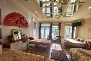 a bedroom with two beds and a living room at Royal Boutique Hotel, Greater Vancouver in Surrey