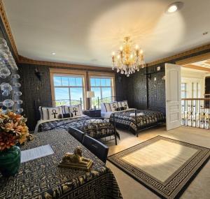 a large living room with couches and a chandelier at Royal Boutique Hotel, Greater Vancouver in Surrey +62 photos