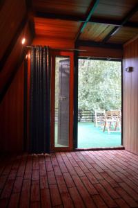 an open glass door in a room with a patio at Biafo Resort Skardu in Skardu
