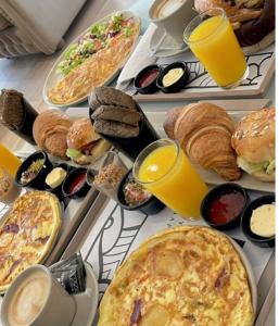 a table topped with plates of breakfast foods and drinks at Sensia Mediterranean Escape in Aouchtame