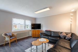 a living room with a couch and a table at Ferienwohnung Carolin in Dornstetten