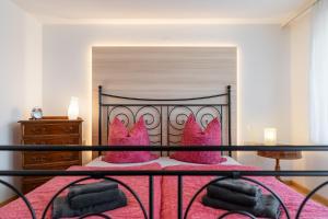 a bedroom with a bed with pink shoes on it at Ferienwohnung Carolin in Dornstetten