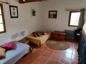 a small room with two beds and a table at Le gîte panda saint-maymes in Trigance
