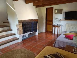 a living room with a fireplace and a couch at Le gîte panda saint-maymes in Trigance
