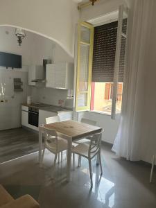 a kitchen with a table and two chairs and a table and a kitchen at Casa mediterranea in Formia