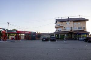 a parking lot with cars parked in front of a building at Motel Atos in Laktaši