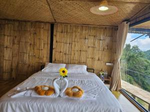 a bed with two teddy bears and a flower on it at Mon Ngo misty haven B4 in Ban Mae Ta Man +3 photos