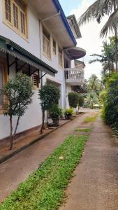 an empty street in front of a white building at Madara Hotel in Horana