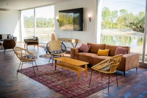 a living room with a couch and some chairs at Les Etangs de la Bassée in Gravon
