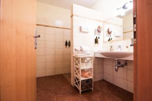 a small bathroom with a sink and a shower at Hotel Garni Zerza in Tröpolach +70 photos