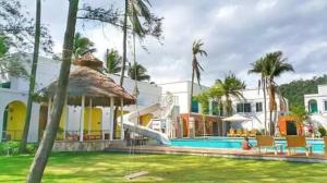 a house with a swimming pool with a slide at Meet The Sea in Khlong Yai