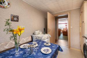 a blue table with a vase of flowers on it at Ferienwohnung Stoll in Brüel in Brüel