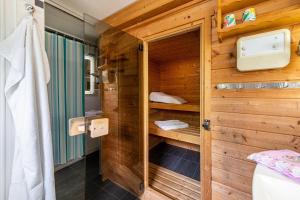 a bathroom with a shower with a wooden wall at Ferienwohnung Stoll in Brüel in Brüel +17 photos