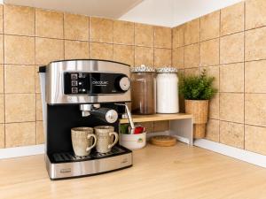 a coffee maker in a kitchen with two coffee cups at Pico Colorao Loft in Soo +10 photos