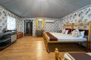 a bedroom with a bed in a room at Sam Sand Dunes Camps Jaisalmer in Sām