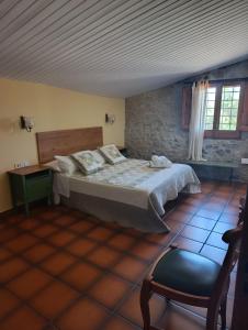 a bedroom with a bed and a chair in a room at Mas Duran in La Pera +71 photos