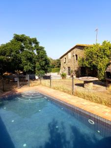 a swimming pool in front of a house at Mas Duran in La Pera