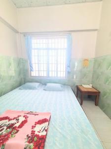 a bedroom with a large bed and a window at Đào Huỳnh Motel in Nam Du