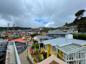 a view of a town with houses and buildings at Nilgiris Stayz - Home Stay at Ooty in Ooty