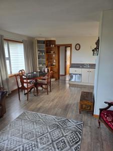 a living room with a table and chairs and a kitchen at Annie's in Methven