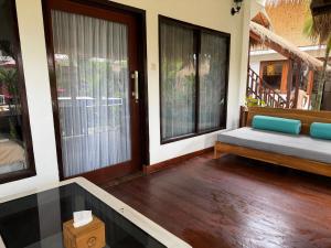 a room with a porch with a bed and windows at Dream Makers Retreat in Gili Islands +57 photos