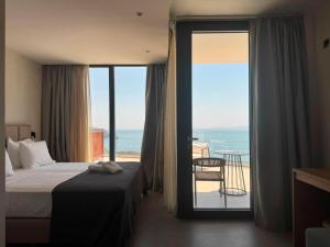 a hotel room with a bed and a view of the ocean at Alon Sevou Boutique Hotel in Syvota +184 photos