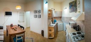 a small kitchen with a table and a counter at Guest house Maison 21 in Plovdiv