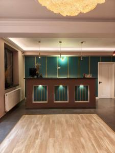 a large room with a dance floor and a chandelier at Otopeni Garden Hotel in Otopeni