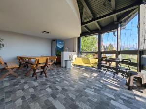 a living room with a yellow couch and a table at Casa Sofisa in Fundata