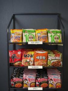 a shelf filled with lots of different types of food at HOTEL THE MAY Jongno in Seoul