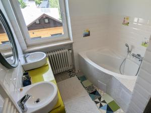 a bathroom with a tub and a sink and a bath tub at Forest Lodge - perfekt für Familien und Freunde in Bayerisch Eisenstein +39 photos