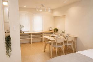 a dining room and kitchen with a table and chairs at Dori Dori House Ebisu in Tokyo
